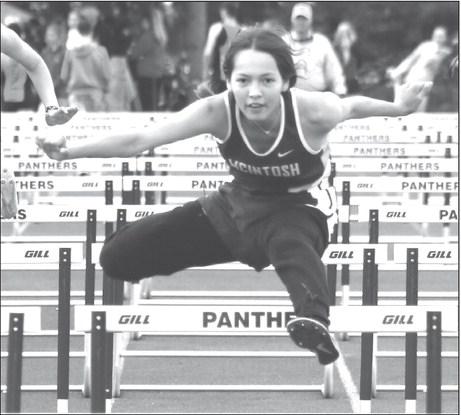 Eighth grader Aleah Hettich of McIntosh eyes the finish line while clearing a barrier in the 100 meter hurdles at the Timber Lake Track Invitational held last Thursday, May 2, at Doug Kraft Field. Hettich won the event and also finished second in the 300 meter hurdles. Photo by Jon Flatland