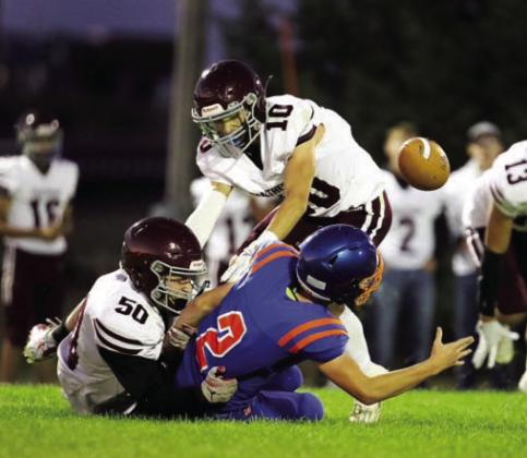 Landon Lemburg (50) and Gavin Farlee (10) force a fumble while bringing down a Stanley County ball carrier in action earlier this season. The Panthers finished the season 4-5 overall after being eliminated from the playoffs last Thursday. Photo courtesy of 605 Sports