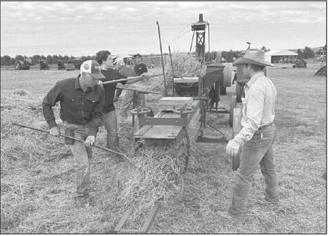 Brian Flatmoe and Teigan Clark of Meadow, Joseph Sterling, Menno, and Brad Hatle, Lemmon, operating the International Harvester Stationary Baler at the Coal Springs Antique Show and Threshing Bee near Meadow last weekend. As always the event drew hundreds of people from across the state and midwest.