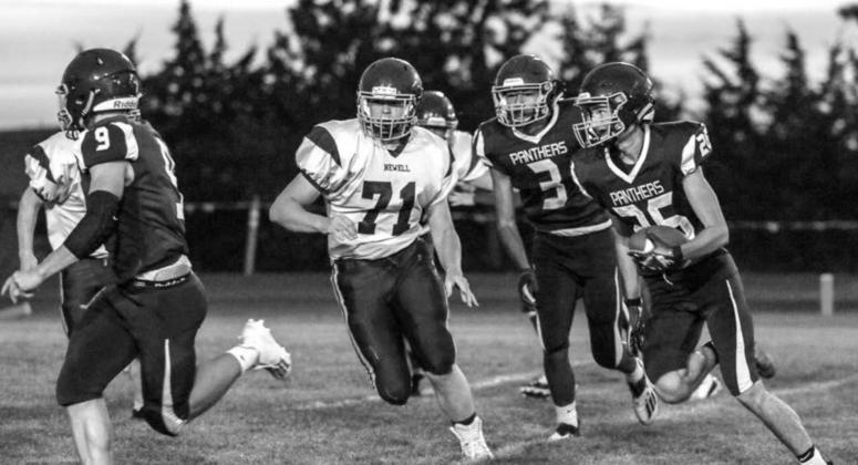 Timber Lake senior Hunter Schrempp (26) runs with the ball as teammates Hank Kraft (9) and Chazz Gabe (3) look to block during their home victory over Newell on Friday. Photos by Jon Flatland