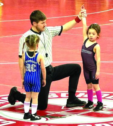Ramzi Veit of the Timber Lake Youth Wrestling Club has her armed raised in victory during one of her matches at the SDWCA State Tournament in Rapid City last weekend. Veit finished third overall in the Girls Tots 40 division.