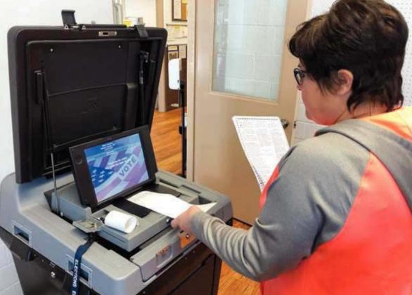 Deputy Dewey County Auditor Cherie Leibel does a test run of ballot tabulating equipment on October 23 in preparation for the November 3 general election. The machine scans and counts the votes on the paper ballots and prints out a ticket to verify the count.
