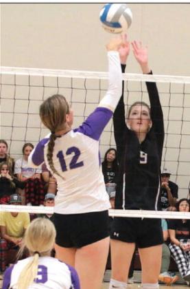 Senior Sara Holzer (9) attempts to block a spike by Harding County’s Jaelyn Wendt (12) in the volleyball season opener last Thursday, Aug. 24. Photo by Jon Flatland