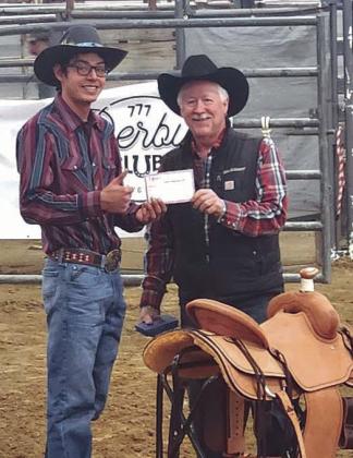 Chazz Gabe of Timber Lake accepts a saddle for winning the bull riding at the NRCA Rodeo in Gillette, WY, last weekend. Gabe also snagged a championship buckle for winning the NRCA season standings.