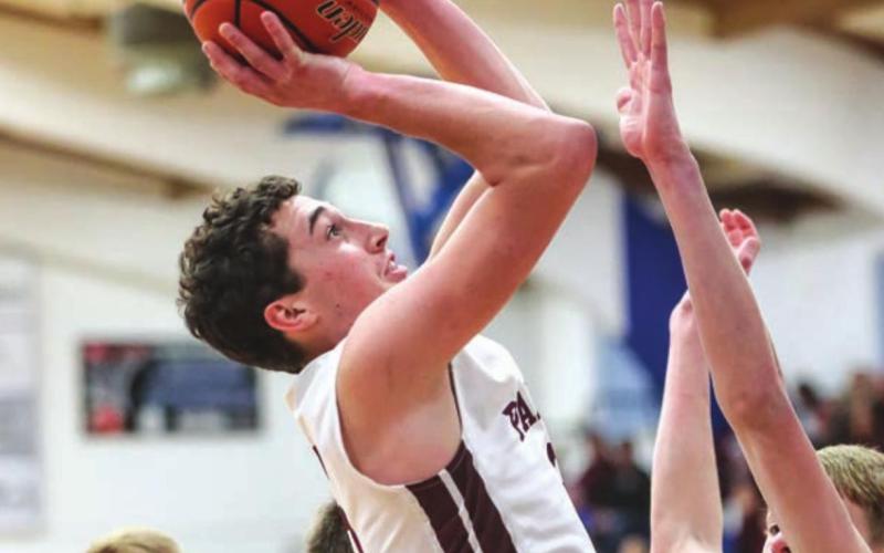 Timber Lake senior Trenton Hansen puts up a shot over Faith’s Corbin Mackaben during the conference tournament finals.