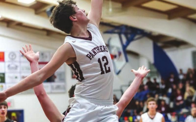 ABOVE: Panther wingman Dixon Booth slashes his way to the basket during the LMC finals versus Faith.