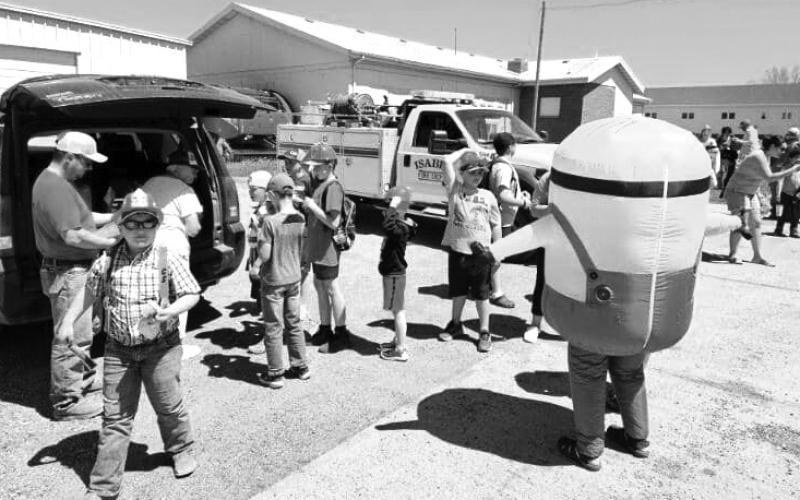 The Isabel Future Visions group and the Isabel Fire Department teamed up to give Isabel kids ice cream treats as they exited the school bus in Isabel on the final day of the school year last Friday, May 17. The kids were given tours of the fire trucks and equipment and entertained by a giant Minion. Submitted Photo