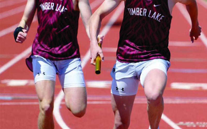 Left, Maddy Hermes won the girls javelin event at the Timber Lake Classic last week with a throw of 34 feet and 3 inches. Above, Landen Bieber passes the baton to Owen Schweitzer during the 800 meter relay., which the Panthers won with a time of 1:40.31. Photos by Marie DuPreez
