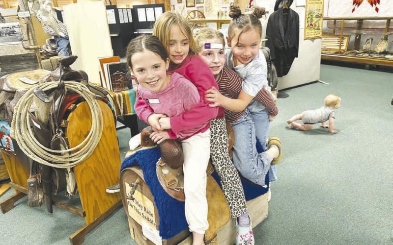 How many bronc riding girls can fit on a saddle?