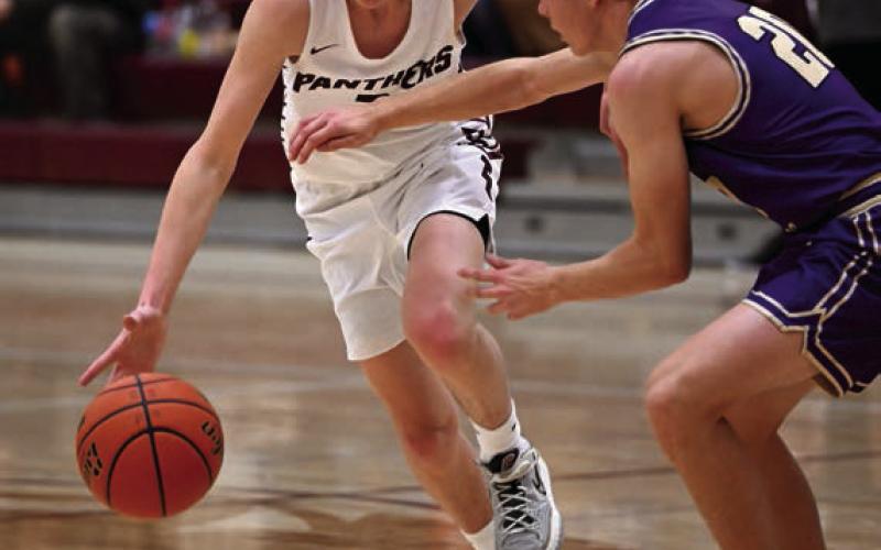 Timber Lake’s Kyler Bollinger, left, pushes the ball upcourt against a Sully Buttes defender during boys basketball action last week.