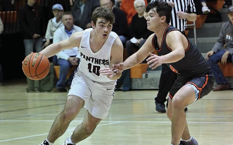 Timber Lake sophomore guard Treyden Beer works the ball upcourt while being harrassed by a Mobridge-Pollock defender during cross-river boys basketball action in Mobridge just before the holiday break. Photo by Marie Du Preez