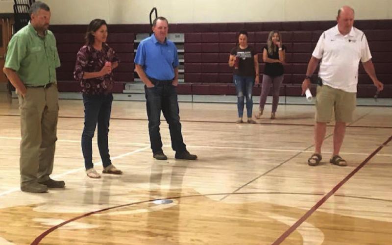 Timber Lake School officials admire the re-designed look of the new wood floor in one of the school's gymnasiums last Wednesday as part of a walking tour through the building to see the progress being made on a variety of improvement projects. L-R are board members Jake Kraft, Rae O'Leary, Bryce Lindskov and Marie Gross; business manager Amanda Hermes and Supt. Dan Martin.