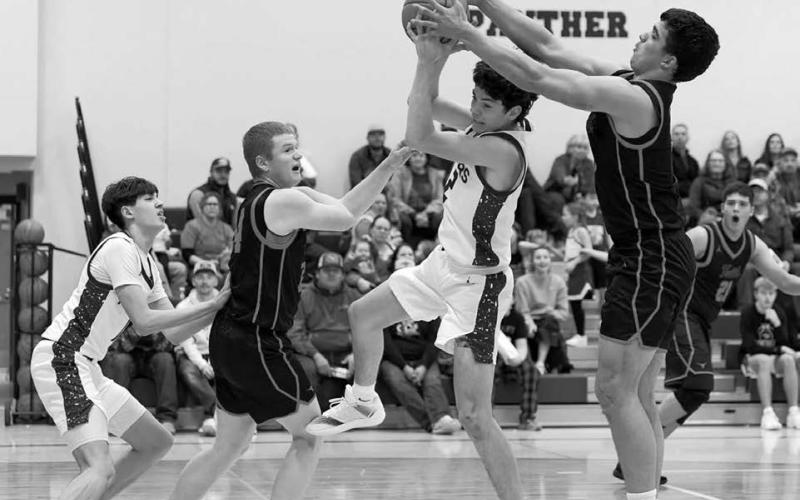 Panther guard Pete Maher splits a pair of Faith defenders on his way to the hoop during Timber Lake’s 59-- 42 win over the Longhorns last Thursday, Jan. 8. Looking on is Jackson Bigger (left). The Panthers are 5-2 overall heading into this week’s schedule. Topic Photo/Marie DuPreez