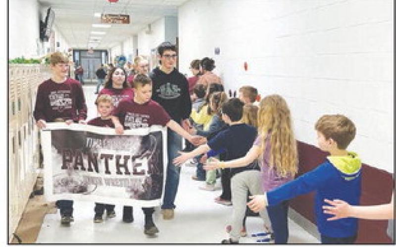 State AAU wrestling qualifiers paraded through the Timber Lake School corridors on Thursday, March 14 to be cheered on by students and staff. Photo by Kathy Nelson