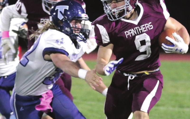 Senior running back Hank Kraft evades a tackler.