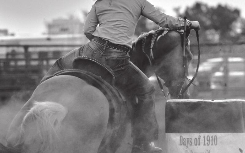 Sydney Maher, Timber Lake, rounds a barrel with the sun setting over Timber Lake during the Days of 1910 rodeo. Maher has been cashing in at recent SDRA events.