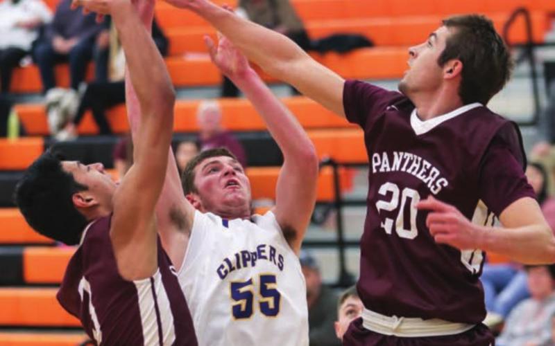 Timber Lake’s Brandt Ducheneaux (20) and Chazz Gabe (3) block the shot of a Strasburg-Zeeland player during their game at Mobridge.