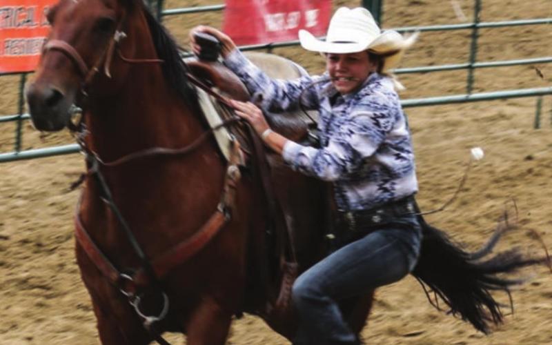 Kennedy McLellan, Dupree, dismounts in 4-H rodeo competition.