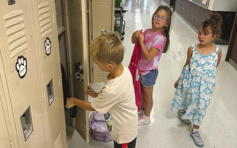 Back to School Finding their new locker is on every student’s checklist on the first day of school. Here Reed Winterberg, Azalea Grage and Lochlyn Goldade find theirs. Photo by Kathy Nelson
