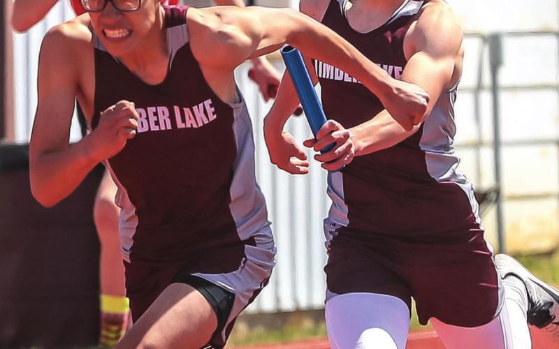 Otto Red Bear has determination on his face as he takes the handoff from Gracen Hansen during their 4x200 relay race at last week’s last chance meet.