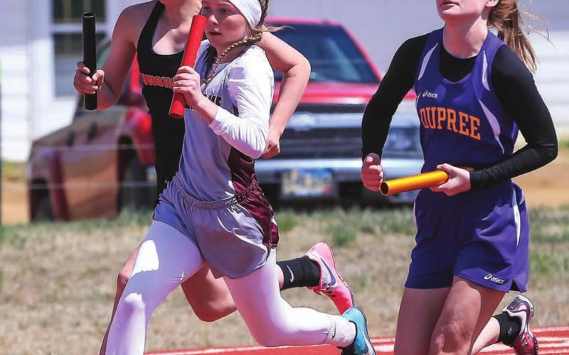 Panther Kenlea Heck (CENTER) strides ahead during a relay race at the last chance meet in Timber Lake.