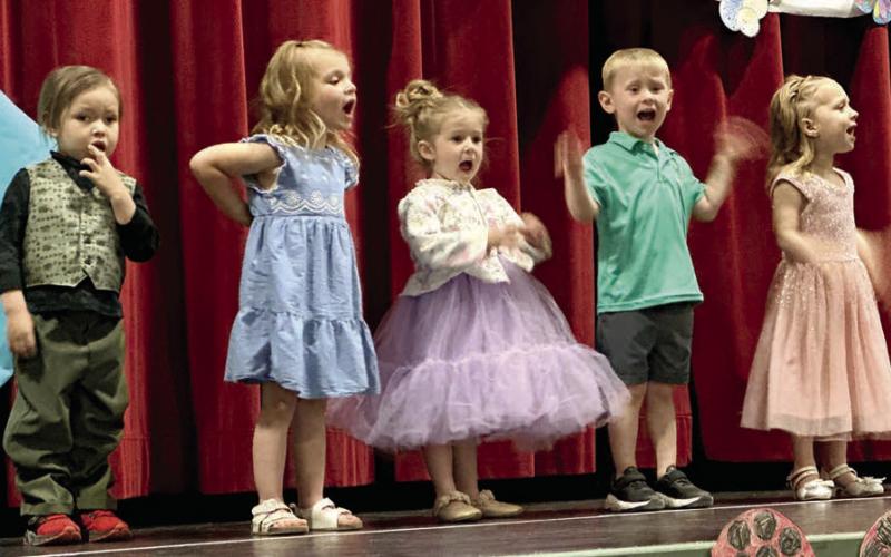 The Timber Lake Head Start kids presented their spring concert in the Timber Lake School theater last Thursday, April 30. Performers included (l-r) Jesper Four Bear, Reagan Kraft, Mia Linderman, Dexter Aberle and Kara Aberle. The stage was decorated with flowers, bumblebees and lady bug art created by the students. Photo by Kathy Nelson