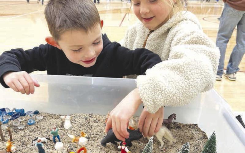 Koleson Long and Piper Schrempp create a miniature campsite complete with tents, trees and wildlife.