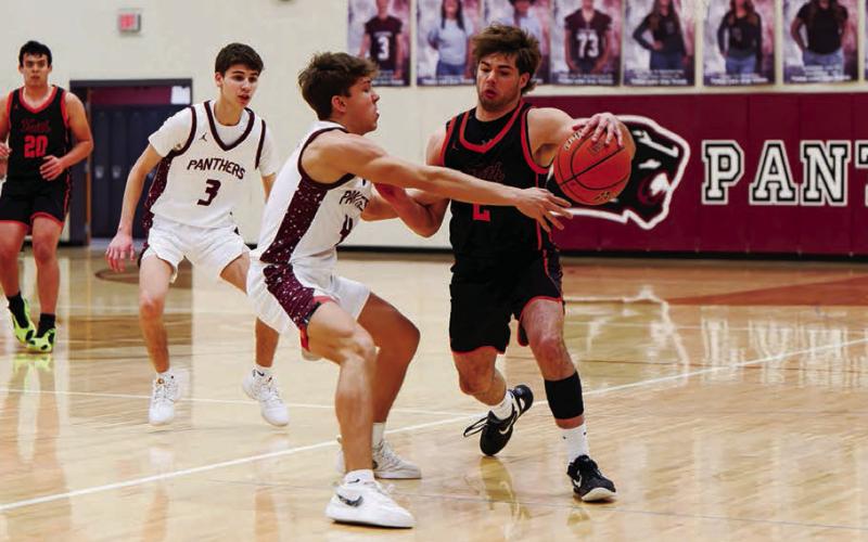 Timber Lake’s Broc Bauer reaches for a steal against a Faith player while Braden Lawrence (3) looks on during a Little Moreau Conference matchup in Timber Lake last week. The Panthers won to improve to 5-2 on the season. Topic Photo/Marie DuPreez