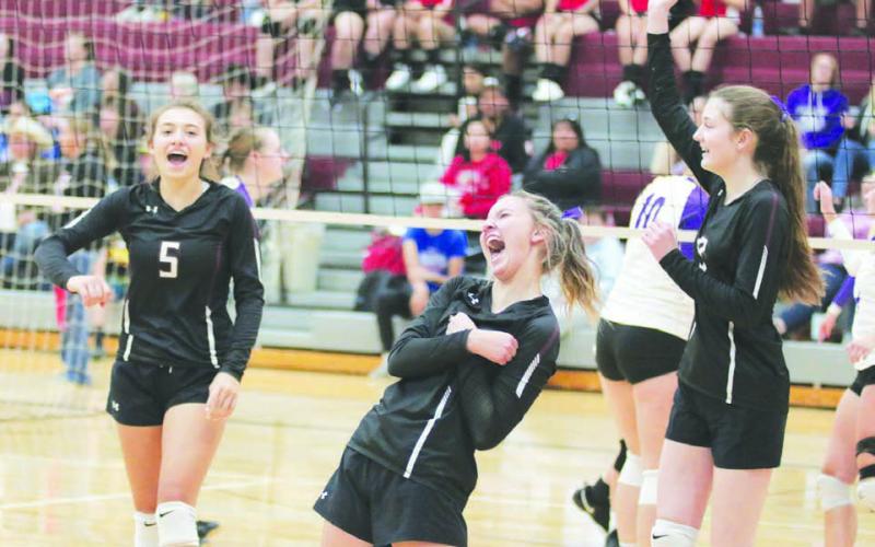 Timber Lake’s Shay Kraft, Carlie Lawrence and Sara Holzer celebrate the winning point in their match against Harding County after overcoming a nine-point deficit in the first round of the Little Moreau Conference Volleyball Tournament played Saturday, Sept. 24, in Faith. Photo by Jon Flatland