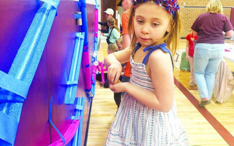Kindergartner Remi Aberle tries out the marble run made from foam.