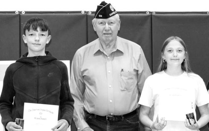 RIGHT: John D. Lemke presented the American Legion 8th Grade Citizenship awards to Walker Farlee and Kyler Hunt.