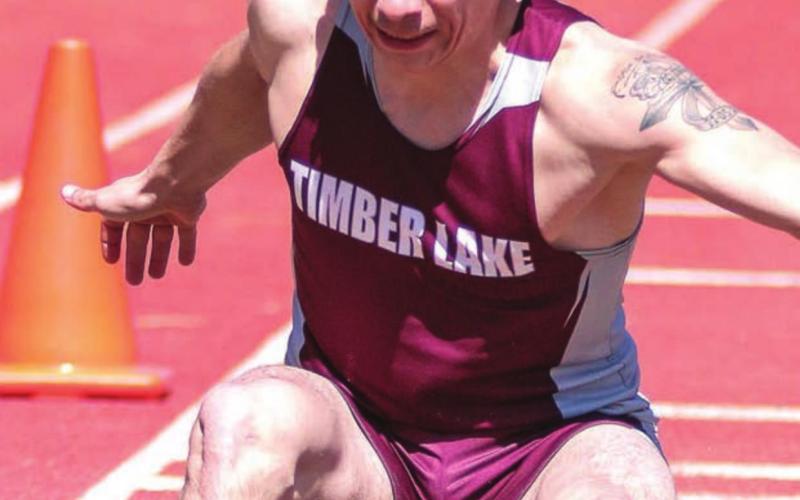 Timber Lake leaper Slater Ducheneaux touches down in the sand pit. File photos by Jon Flatland