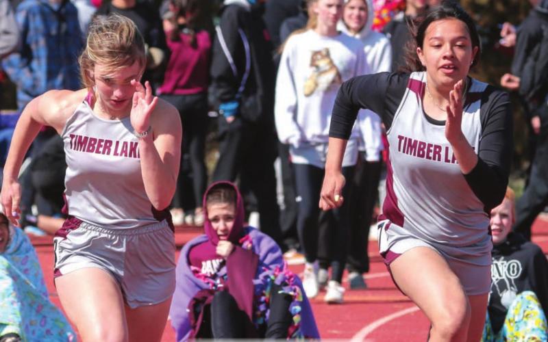 Timber Lake runners McKenzi Vomacka (L) and Kessa Bigger sprint out of the blocks.