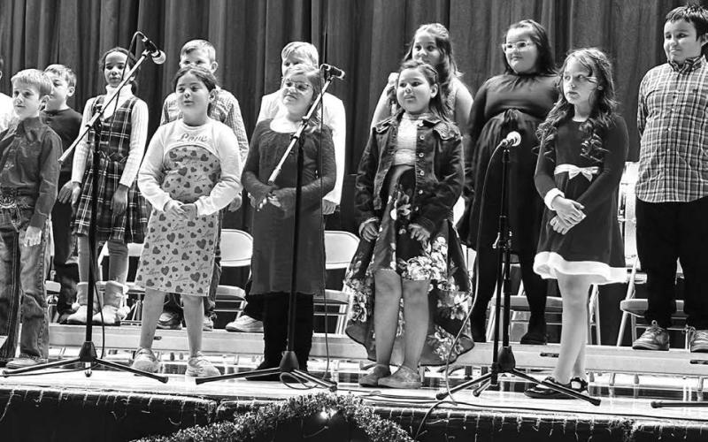 Timber Lake Elementary students, under the direction of K-12 music instructor Walker Rose, entertained the audience with a concert of holiday music on December 5. Above: Third graders. Right: Fourth graders .