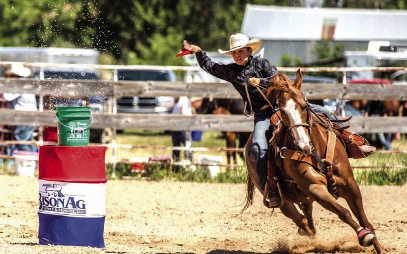 Above, Tripp Burress of Isabel makes the turn after snatching the flag during the flag race at the Perkins County 4-H Rodeo in Bison last weekend. Below, Kennedy McClellan of Dupree gets after it in the goat tying event at the Dupree Pioneer Days Rodeo. Due to space limitations, look for the Perkins County 4-H Rodeo results and photos on the Topic Facebook page.