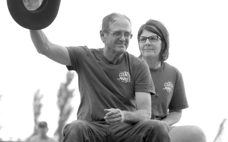 John and Patty Linderman, owners of Country Market in Timber Lake, were honorees at the Days of 1910 Rodeo on Saturday evening and circled the arena on a horse-drawn wagon to the acknowledgement of the crowd. John is waving the hat that belonged to the late Glen Cudmore, longtime rodeo volunteer. Photos by Jon Flatland