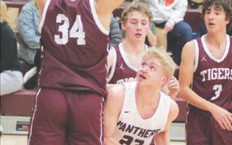Timber Lake’s lone senior, Brady Sandquist (23) looks for a shot while being defended under the basket during recent action against McIntosh. Photo by Jon Flatland