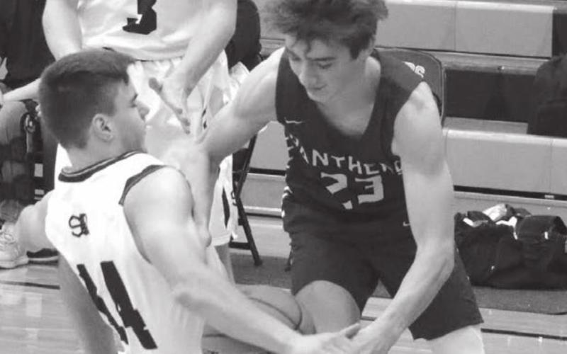 Timber Lake’s Gavin Farlee draws a blocking foul while advancing the ball during the Mobridge Rotary Classic. Photo by Jon Flatland