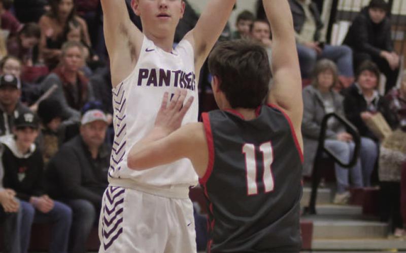 Panther guard Kyler Bollinger looks to pass inside while being defended by Potter County’s Kyler Van Well during non-conference boys basketball action in Timber Lake last Friday, Feb. 24. Bollinger contributed 13 points to the Panthers’ 70-49 victory. Photos by Jon Flatland