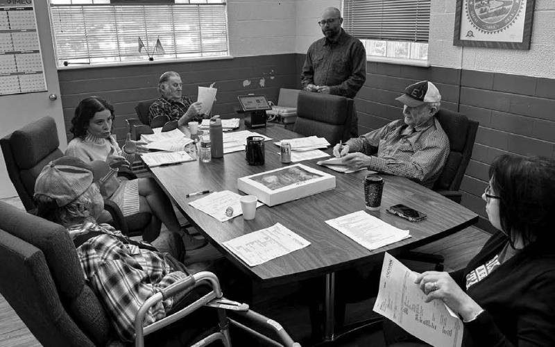 Dustin Van Balen (standing) explains the KNOWiNK pollbook system to the Dewey County Commission. Seated (clockwise from lower left) are Bob Keckler, Auditor Jamalia Franzen, Bob Berndt, Rod Enright, and Dee Ann Lawrence.