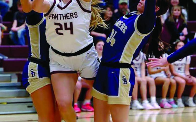 Panther freshman Maddy Hermes (24) draws a foul while driving to the basket between two Sully Buttes defenders. Timber Lake rallied in the fourth quarter to down the Chargers 57-49. Topic Photo/Marie DuPreez