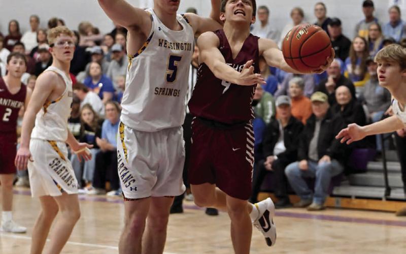 Timber Lake freshman Broc Bauer (right) came off the bench to score five points during the Panthers’ loss to Wessington Springs in the SoDak 16 last week. See Page 10 for game coverage. Photo by Marie DuPreez