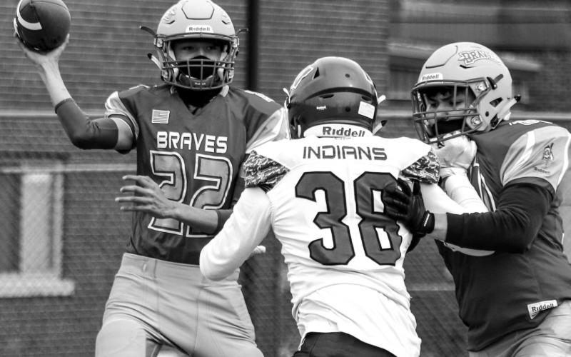 Cheyenne-Eagle Butte quarterback Ayden Sampson (22) passes the ball during the All Nations Conference football opener Friday at Eagle Butte. Photo by Jon Flatland