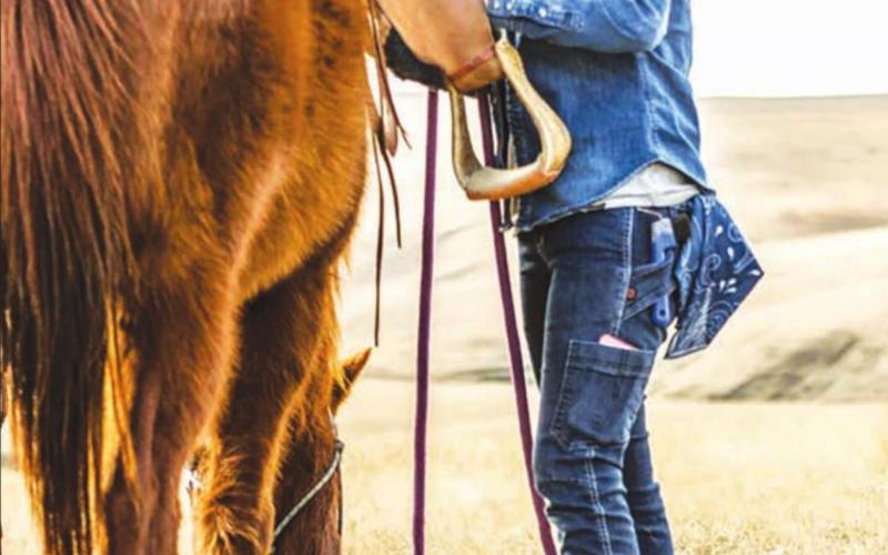 Kelsey Ducheneaux, co-owner of DX Ranch near LaPlant, models some of the new women’s ranchwear clothing line she and her crew inspired and influenced for Dovetail Workwear, a women-owned clothing label based in Portland, OR. Photo courtesy of Dovetail Workwear