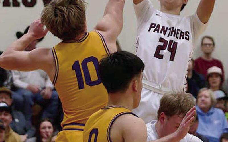 Sophomore forward Kanton Hunt (24) shoots over Dupree defender Braydon Terveen-Smith (10) during the Region 8B quarterfinals in Timber Lake last Thursday, March 6. Hunt finished the game with a team-high 20 points, including three 3-pointers in the first quarter. Photo by Marie DuPreez
