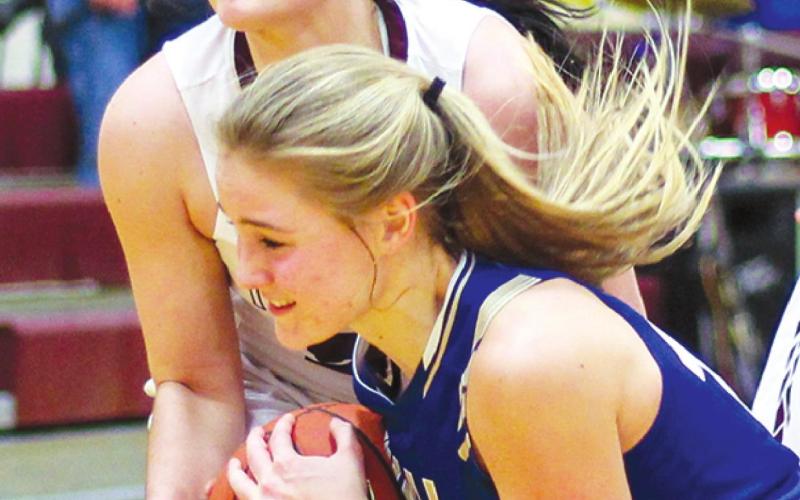 Timber Lake forward Maci Maher (TOP) wrestles an unidentified Wall player for possession of a loose ball during girls hoops action on Friday. Photo by Jon Flatland