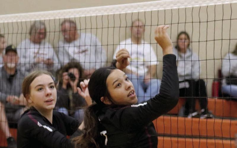 Timber Lake’s Geana Bollinger (left) and Kessa Bigger react to a partially blocked spike during a regular season matchup with Newell. The Panthers downed the Irrigators last week in the Region 8B Tournament. Photo by Jon Flatland