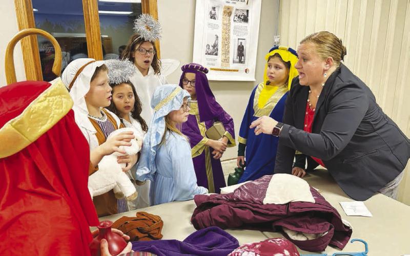 Director Sarah Schweitzer gives last minute instructions to cast members at the Holy Cross K4J Christmas program on December 17. L-R are Brody Kraft, Remi Wiedmer, Cheyienna Nygaard (in back), Stella Nilson, Sophia Gross, and Finley Boldt.