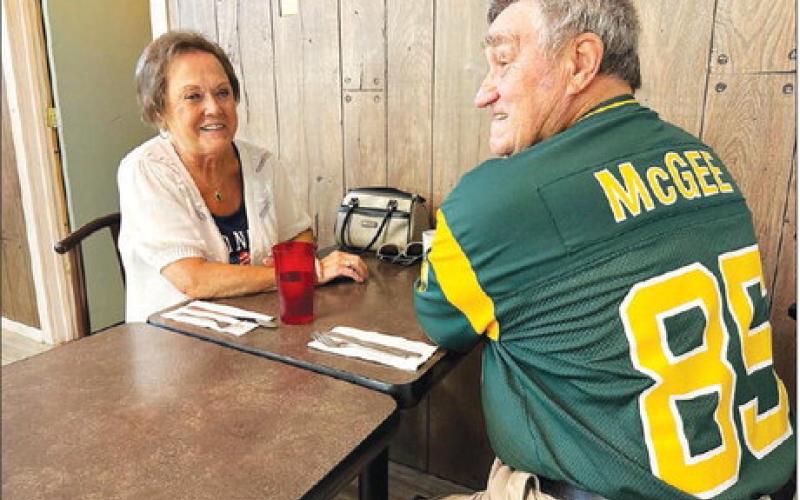 Jim Rolfes, part-owner of the Green Bay Packers, sports his Green Bay #85 Max McGee jersey while having breakfast with his wife, LuElla (Meyer) at Timber Lake during the Days of 1910.