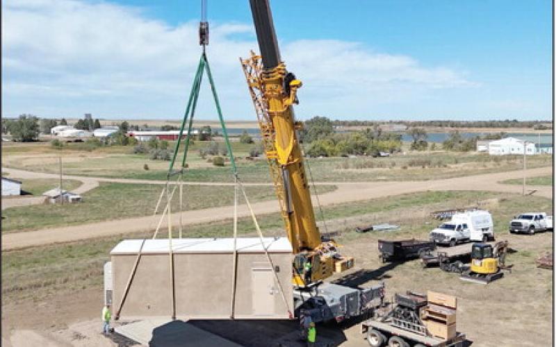 A crane was brought in last Wednesday, Sept. 18, to drop the new central office of the CRST Telephone Authority rural broadband expansion project into place on the east edge of Timber Lake near the rodeo grounds. Topic photo by Roger Lawien